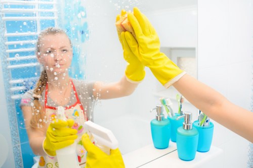 Cleaner maintaining a tidy kitchen during a regular cleaning visit in Finchley